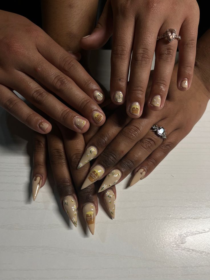 Chic Nude and Beige Nail Design with Intricate Artistic Touches.