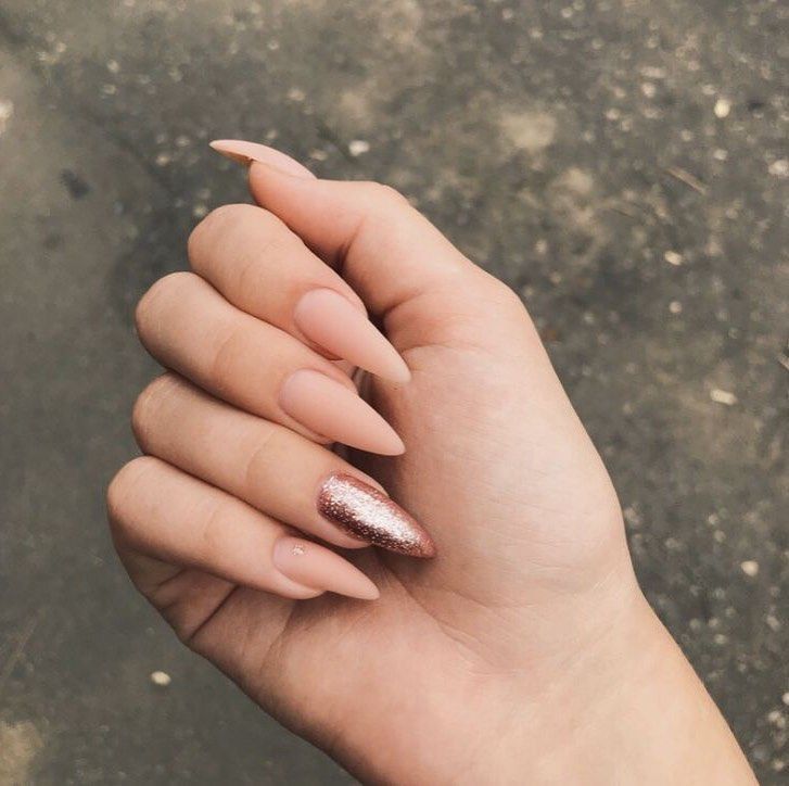 Chic Almond-Shaped Nude Nails with a Glamorous Rose Gold Accent.