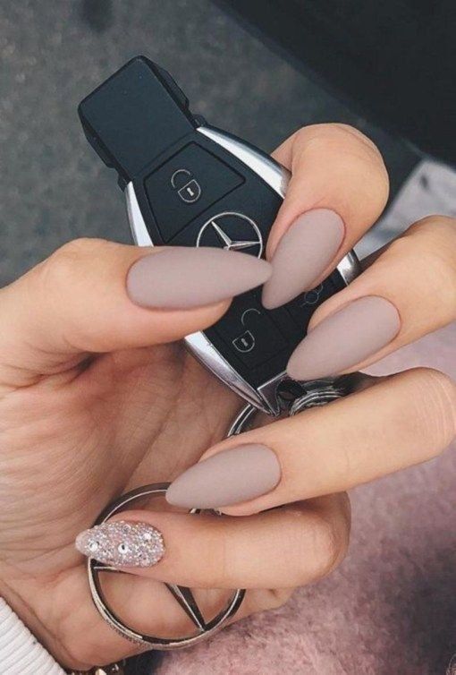 Chic Almond-Shaped Nails with Matte Taupe Finish and Glittery Accent for Modern Sophistication.