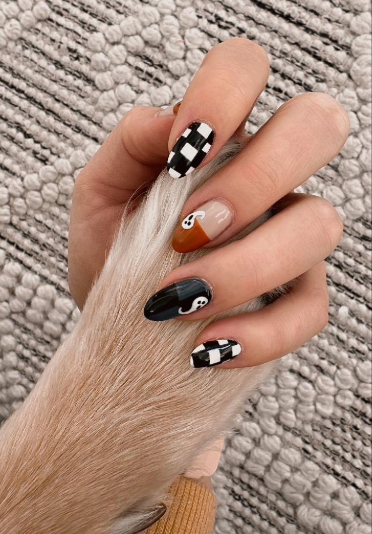 Chic Nail Design with Bold Patterns, Whimsical Ghosts, and Seasonal Colors.