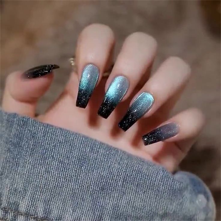 Dramatic Ombre Nails: Black to Shimmering Teal and Silver Gradient in Elongated Coffin Shape.