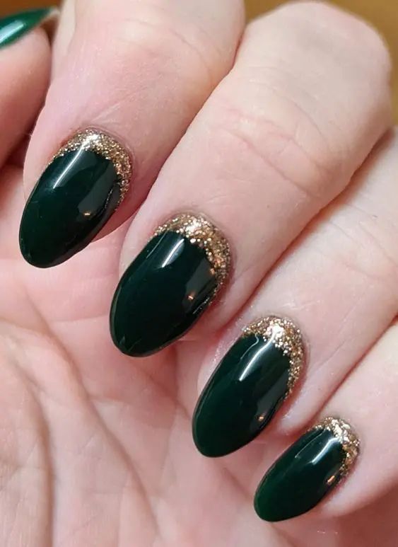 Sophisticated Green Tapered Nails with Glossy Finish and Gold Glitter Accents.