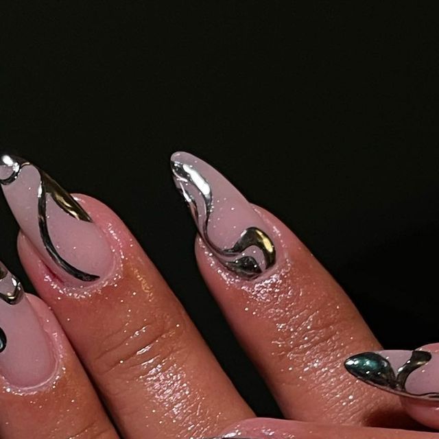 Elegant Almond-Shaped Nail Art: Soft Pink Base with Metallic Silver and Black Accents