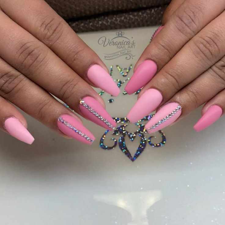 Sophisticated Pink Stiletto Manicure with Matte Finish and Rhinestone Accents.