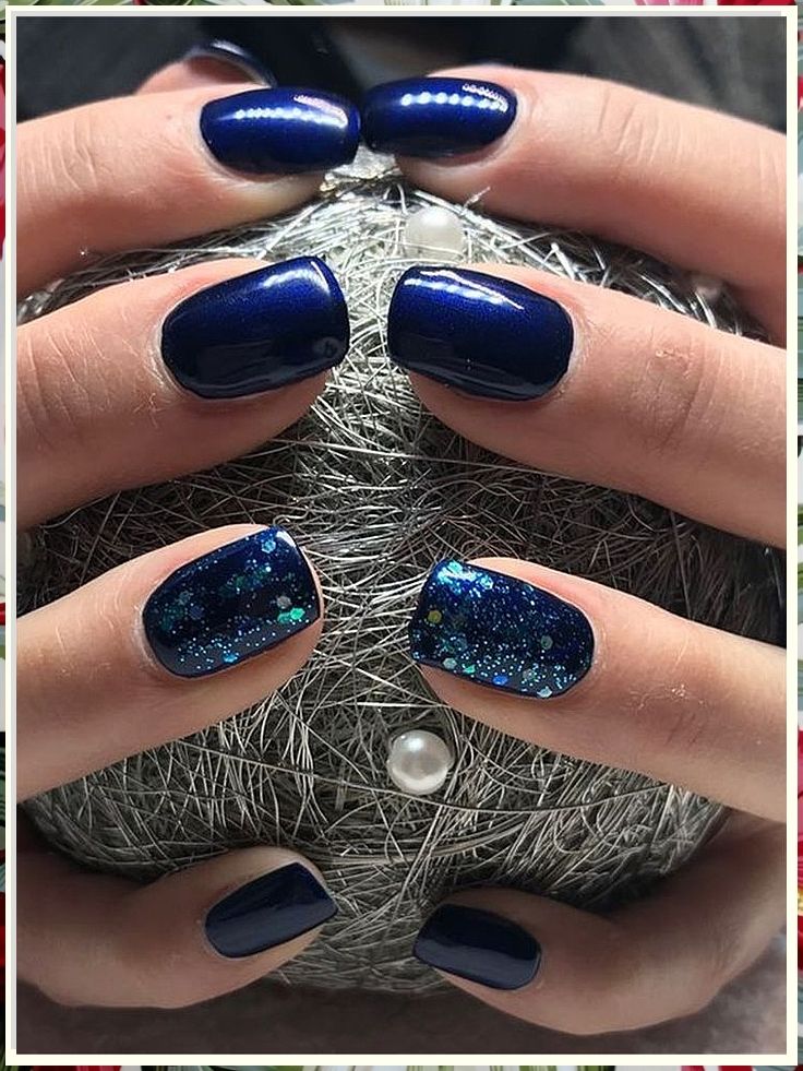 Elegant Deep Navy Nail Design with Glitter Accents for a Sophisticated Look.