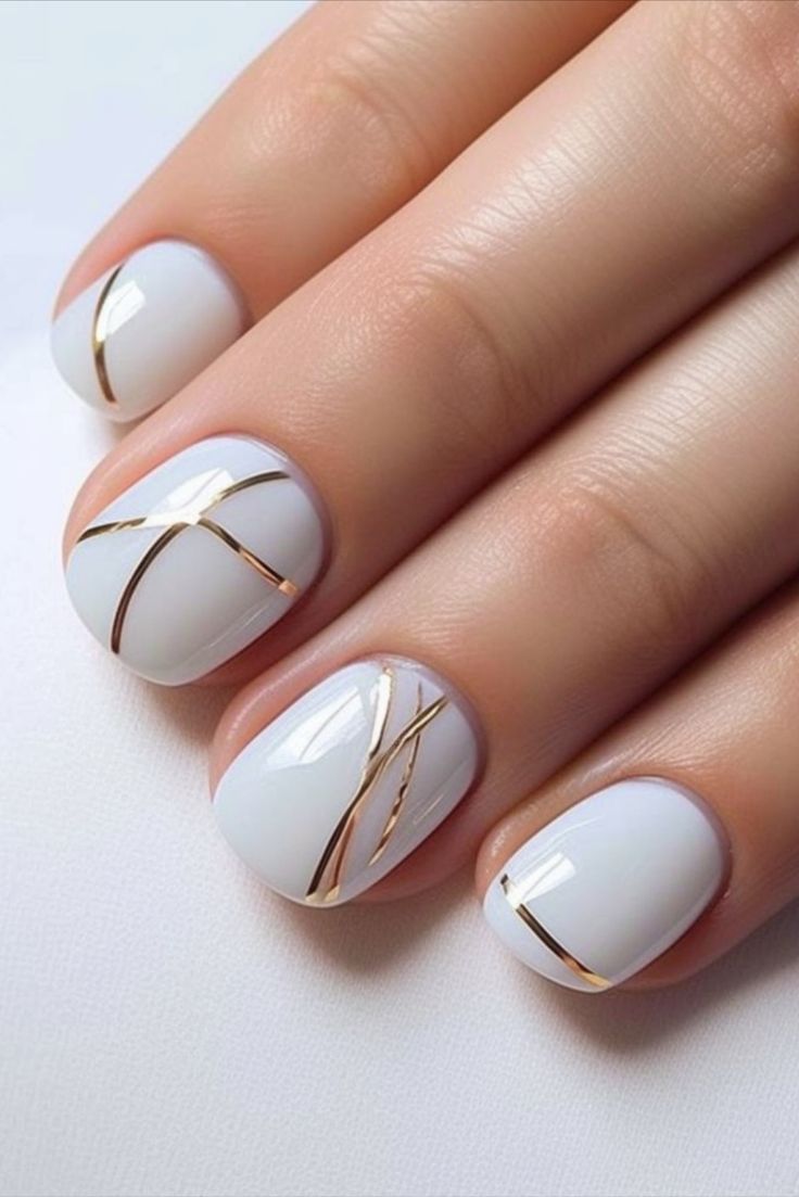 Chic Minimalist Nail Design: Elegant White Base with Delicate Gold Lines