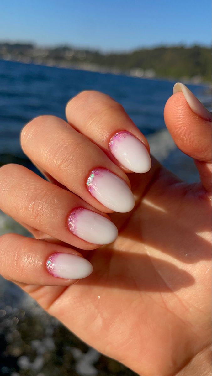 Chic Almond-Shaped Nails with White-Pink Ombre and Subtle Sparkle for a Fresh Summer Look.