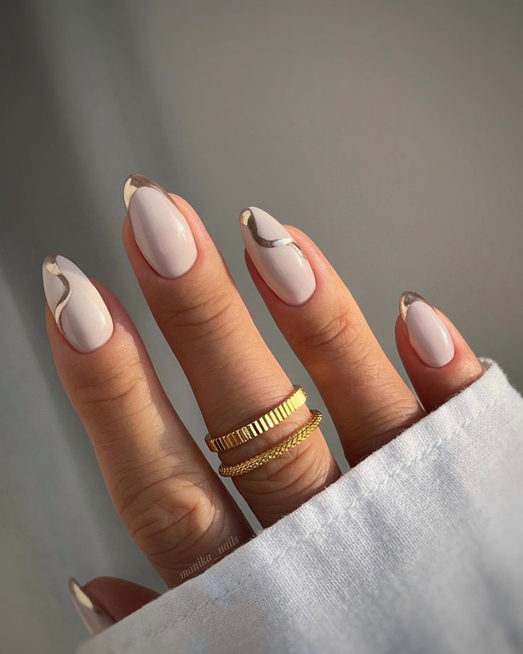 Sophisticated Almond-Shaped Nail Design with Soft Colors and Gold Accents.