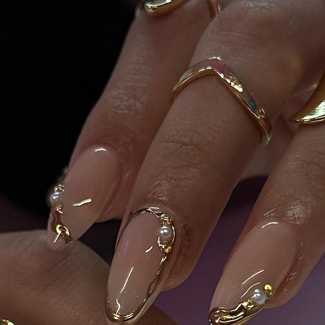 Sophisticated Nude Nail Design with Gold Accents and Pearls for Elegant Occasions.