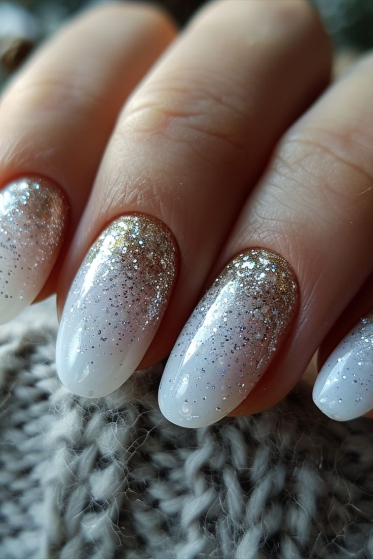 Chic Ombre Nails: Soft White Base to Sparkling Gold Gradient for Glamorous Elegance.