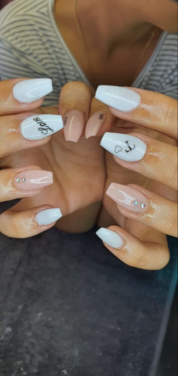 Chic Nail Design: Soft White and Nude Shades with Embellishments and Glossy Finishes for Elegant Aesthetics.