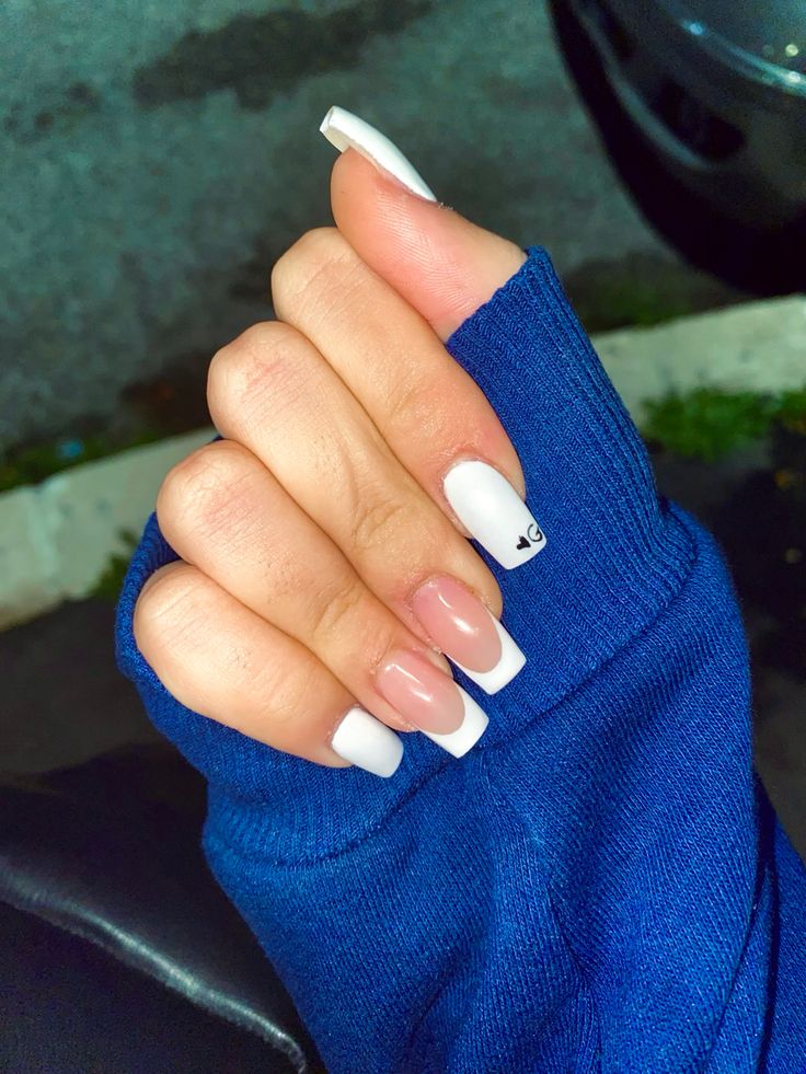 Elegant French Manicure with White and Nude Shades Featuring a Creative Accent Nail.