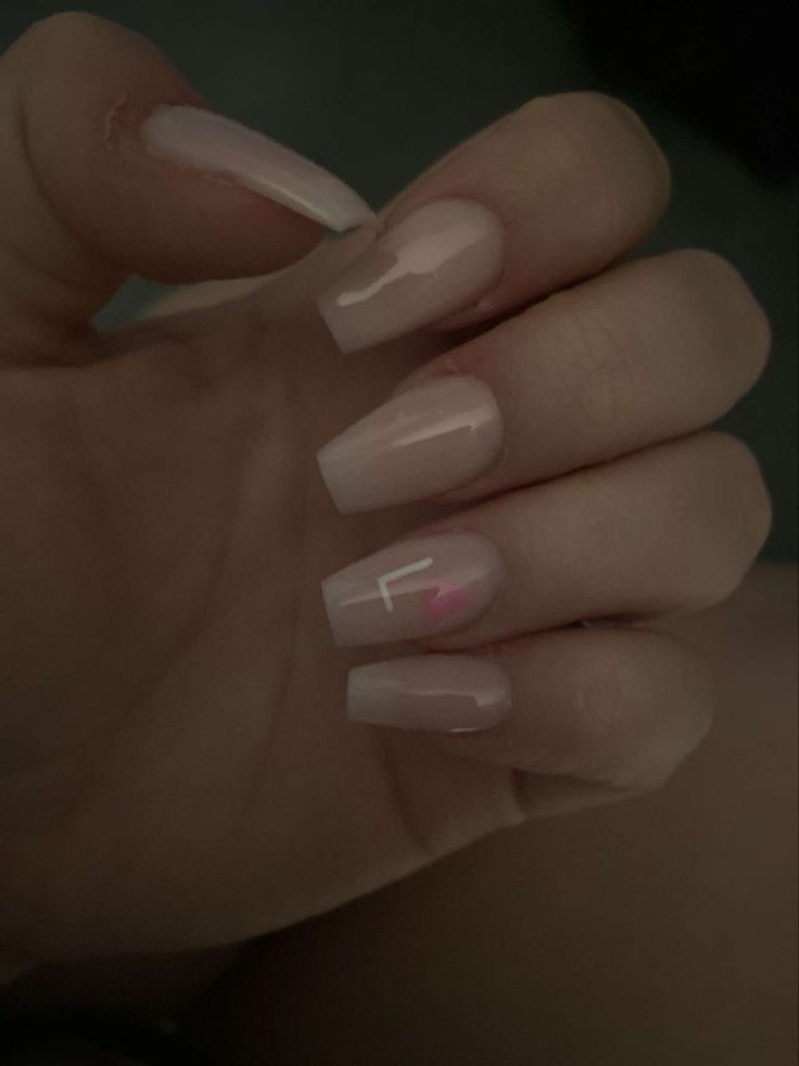 Elegant Nude Nail Design: Glossy Finish with Subtle Accents for Versatile Style.