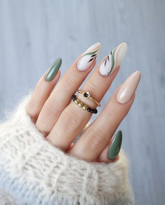 Chic Pastel Almond Nail Art with Abstract Accents and Sophisticated Rings.