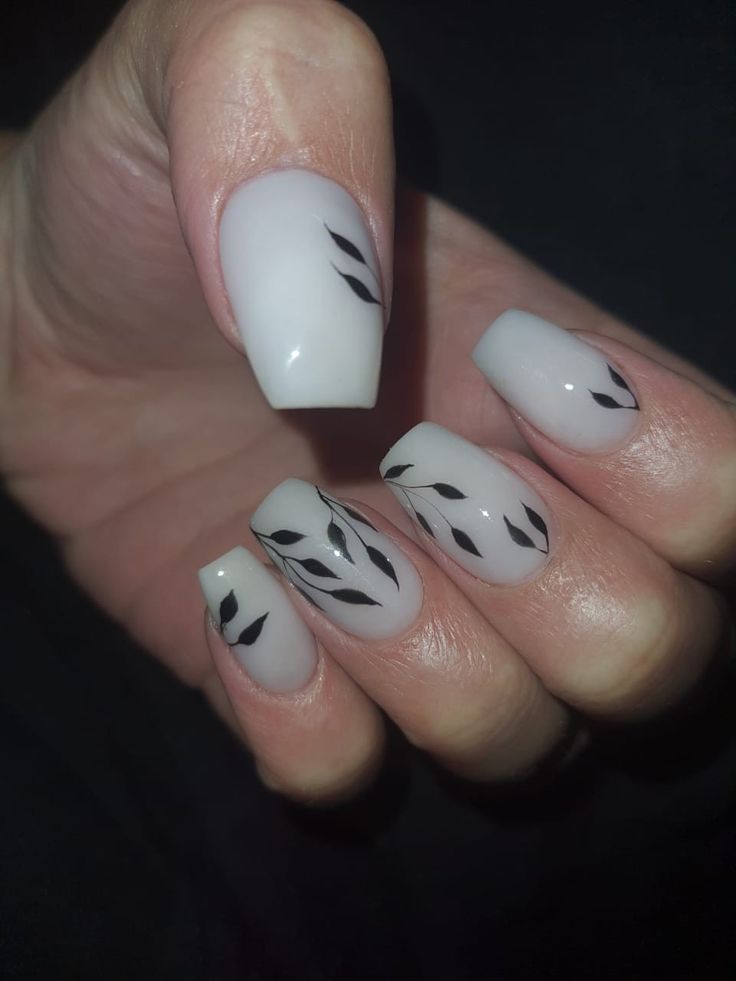 Chic Minimalist Nail Design with Glossy Finish and Delicate Black Leaf Patterns