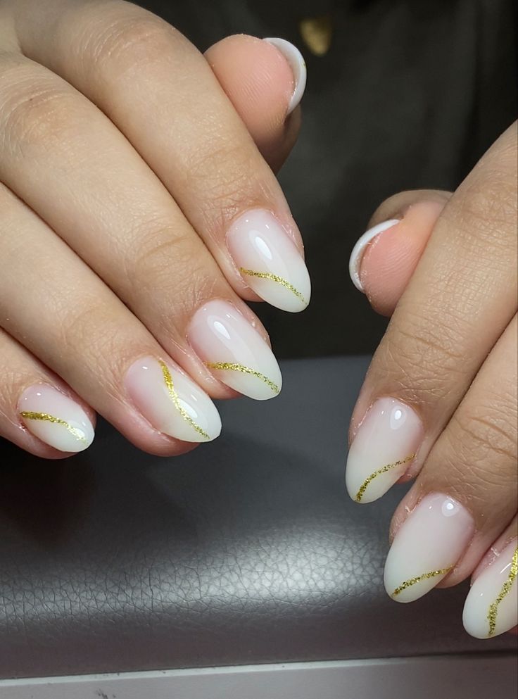 Sophisticated Nail Design: Soft White Base with Subtle Gold Accents