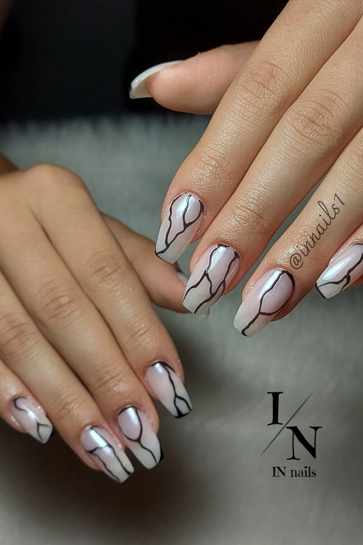 Chic White Base Nail Design with Abstract Black Lines and Matte-Gloss Finish.