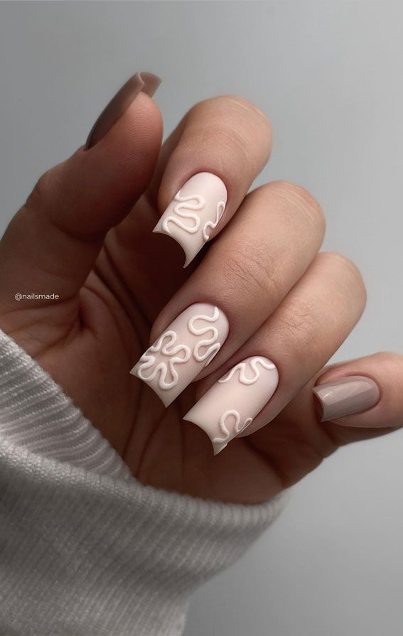 Chic Pastel Nail Design with Playful Swirls and Textured Finishes.