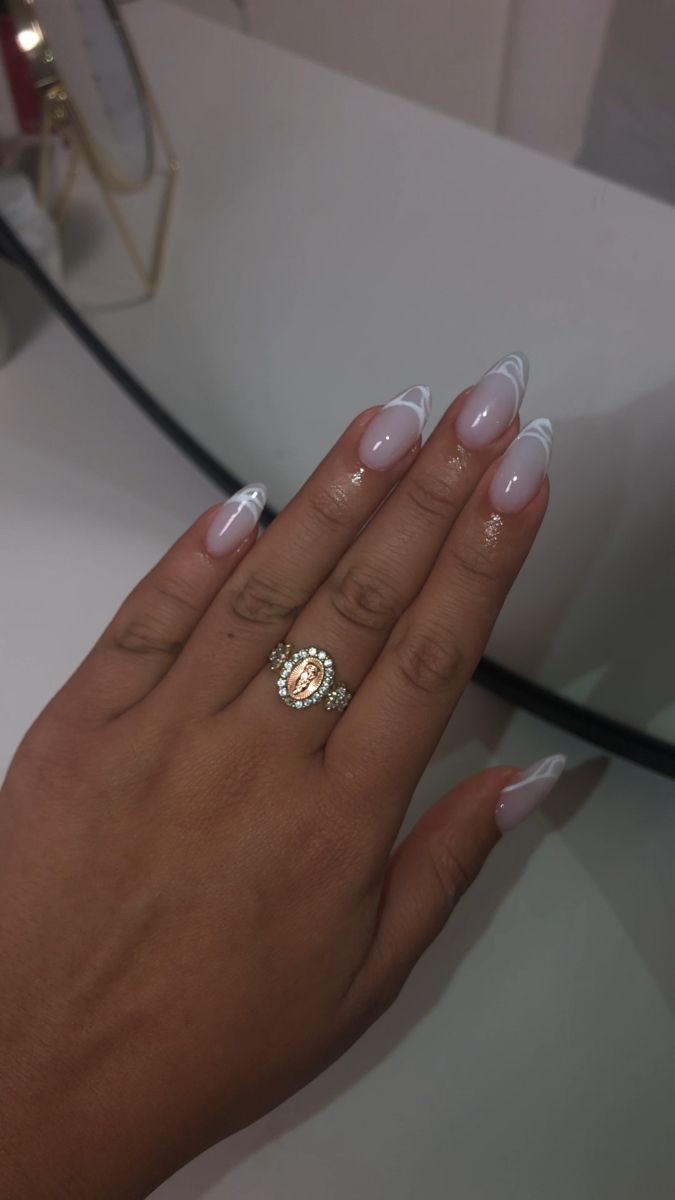 Chic Almond-Shaped French Manicure with Glossy White Tips and Elegant Accents.