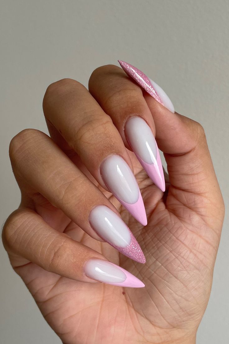 Elegant Soft Pink Nail Design with Pointed Shape and Glitter Accent.