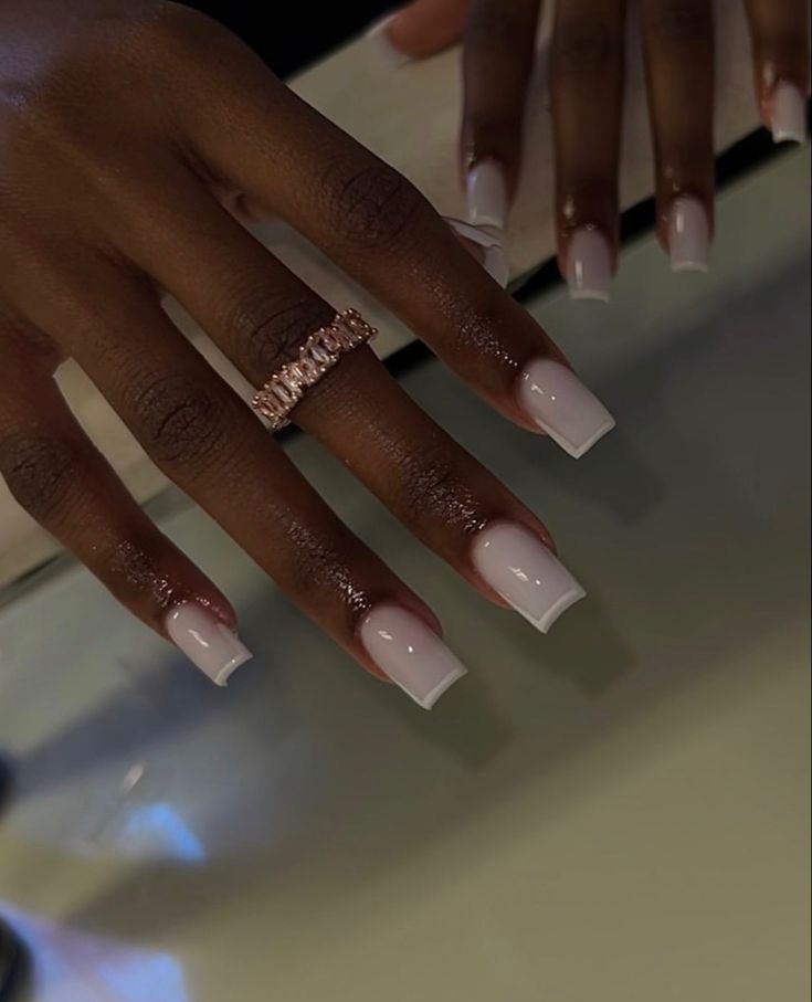 Sophisticated Nude Nail Design with Subtle Gradient and Glamorous Ring Accent.