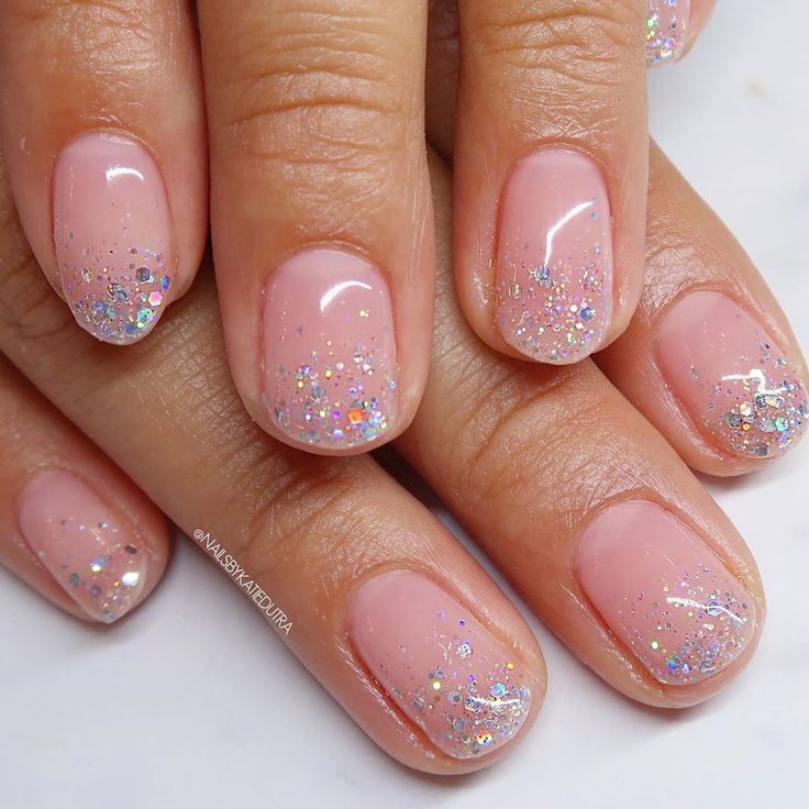 Elegant Sparkling Ombre Nail Design with Soft Pink and Glitter Tips