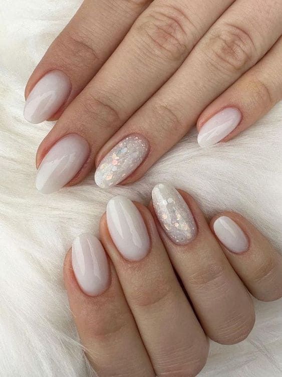 Elegant Milky White Nail Design with Shimmering Glitter Accents