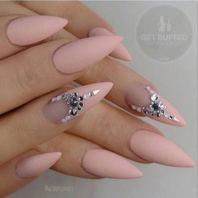 Sophisticated Almond-Shaped Nails with Soft Matte Pink Finish and Glamorous Silver Accents.