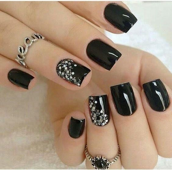 Elegant Black Nail Design with Glossy Finish and Intricate Silver Accents.