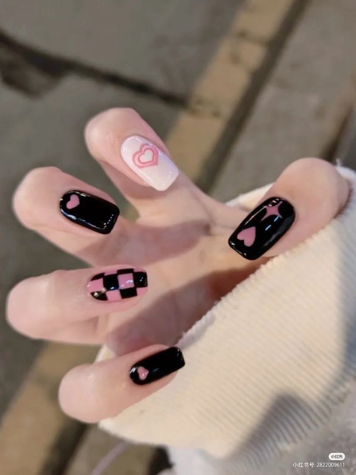 Playful Trendy Nail Design with Heart Motifs and Checkerboard Pattern in Black, Pink, and White.