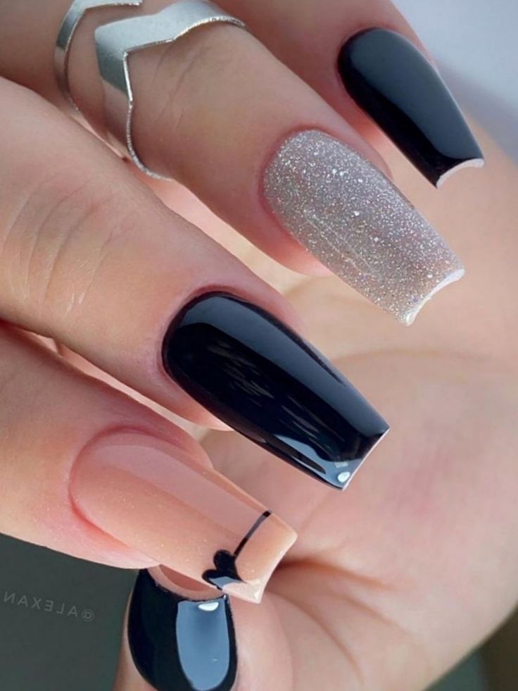 Elegant Glossy Black and Nude Nail Design with Sparkling Silver Accents.