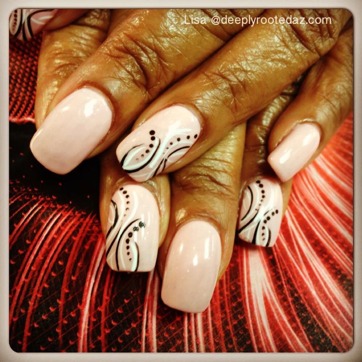 Elegant Nude Nail Design with Intricate Black Swirls and Glamorous Embellishments.