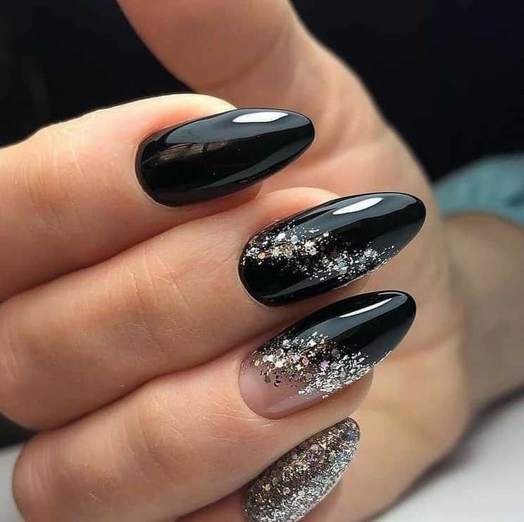 Glamorous Elegant Black Nail Design with Glossy, Textured Finishes and Sparkling Silver Accents.