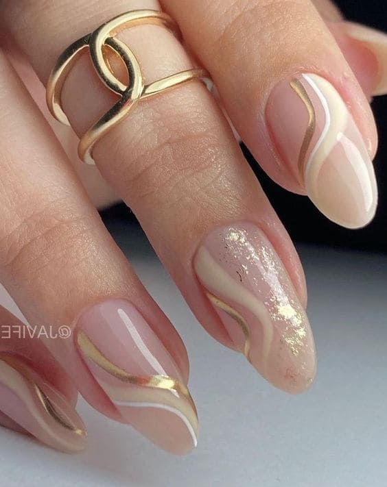 Chic Nail Design: Nude Pastels with Gold Accents and Sparkle