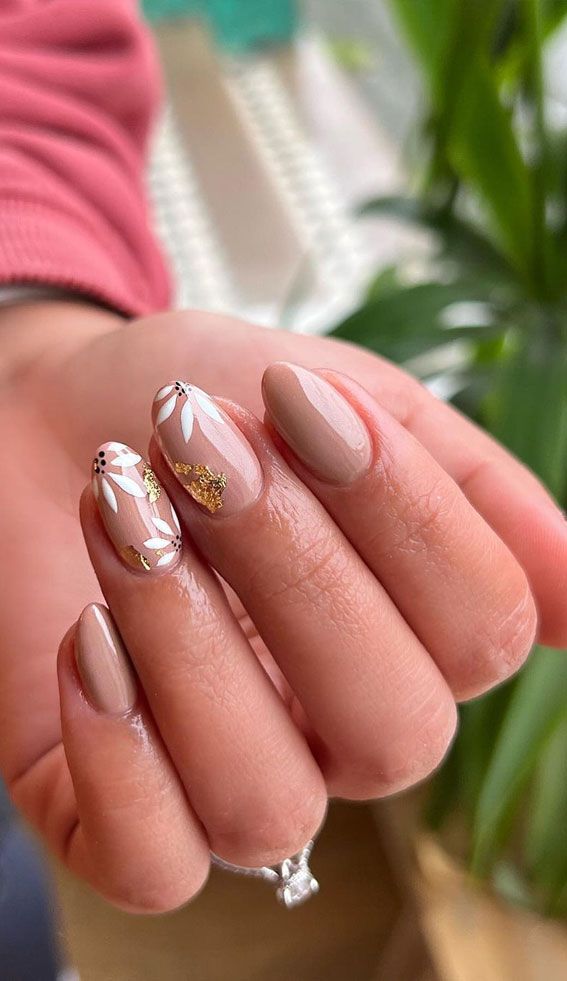 Elegant Floral Nail Design with Soft Nude Base and Gold Accents.