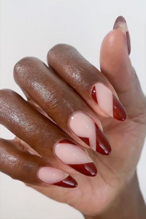 Elegant Nail Design with Striking Deep Red Accents and Soft Nude Base.