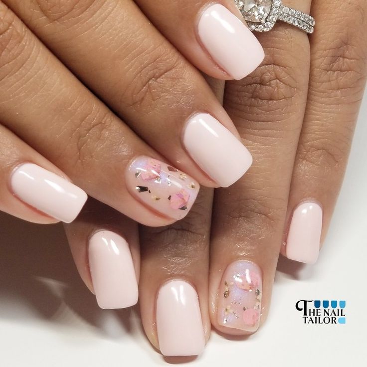 Elegant Soft Pink Manicure with Pastel Accents and Gold Flecks.