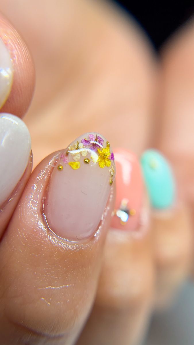 Elegant Floral Nail Design with Colorful Accents and Pastel Shades.