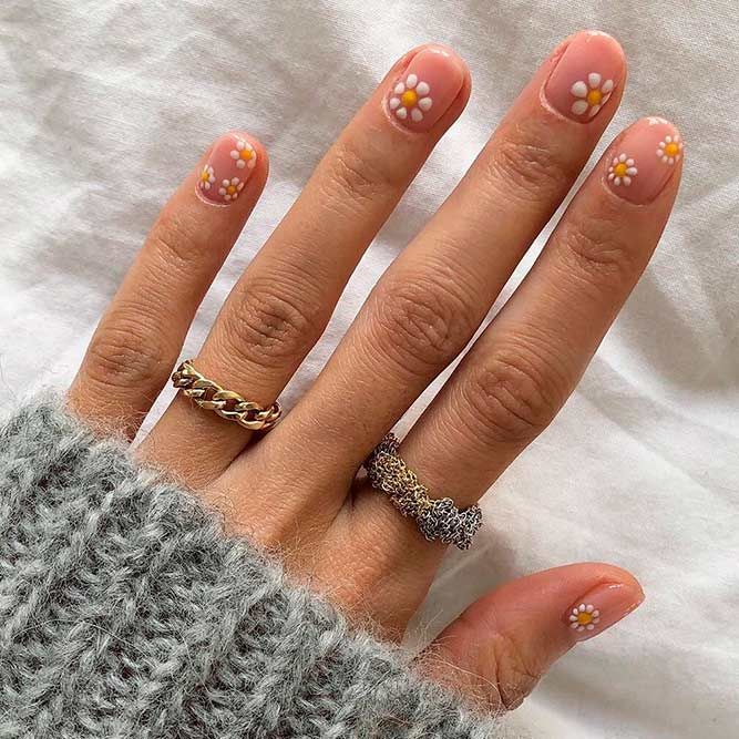 Whimsical Floral Nail Art with Daisies on Nude Base for a Relaxed Stylish Look