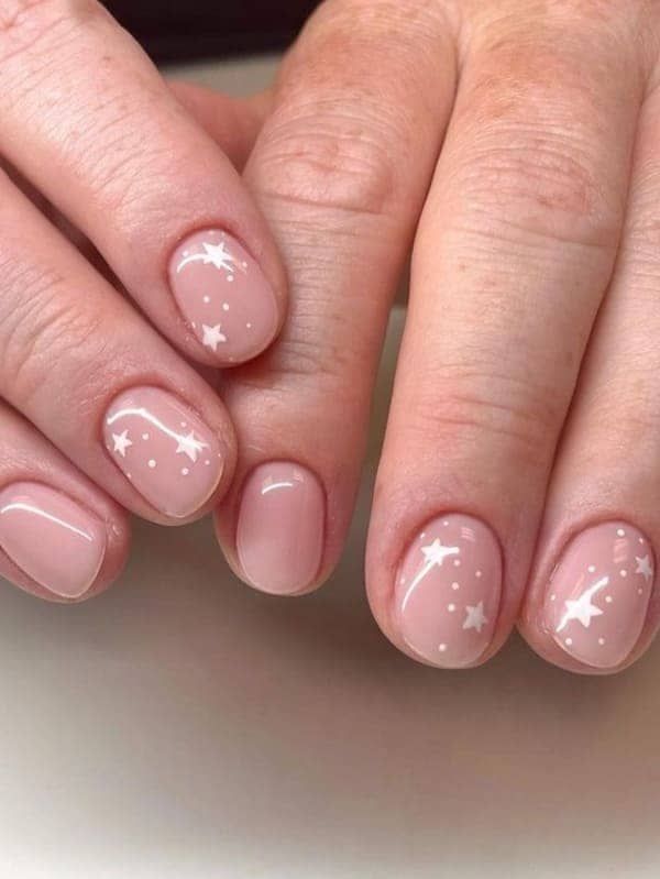 Whimsical Elegance: Soft Nude Nail Design with Delicate White Star Motifs