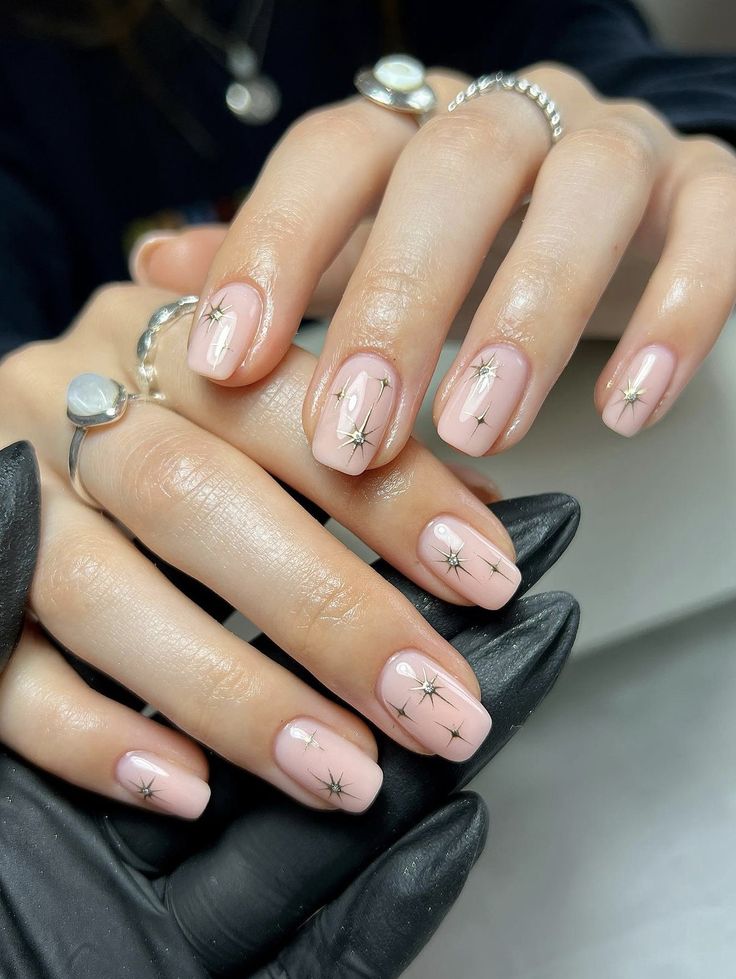 Chic Celestial Nail Design with Soft Nude Base and Delicate Star Embellishments