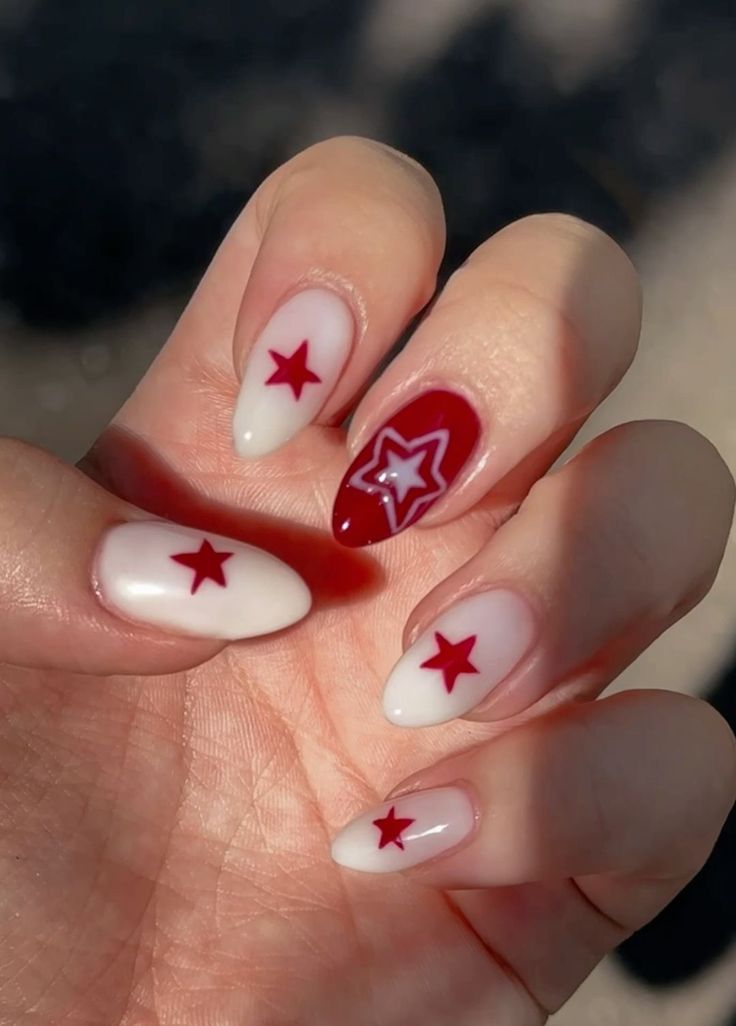 Bold Nail Design: Vibrant Red and Soft White with Playful Star Motifs for a Striking, Elegant Look.