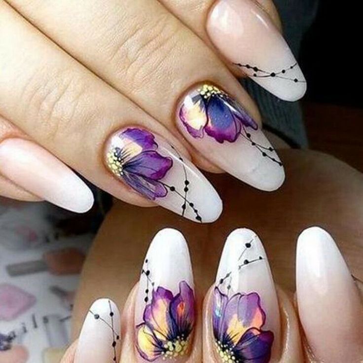 Elegant Purple and Gold Floral Nail Design on Soft Beige Base.