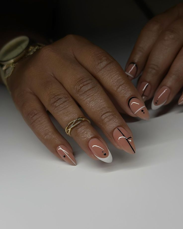 Chic Almond-Shaped Nails with Modern Geometric Patterns in Nude, White, and Black.