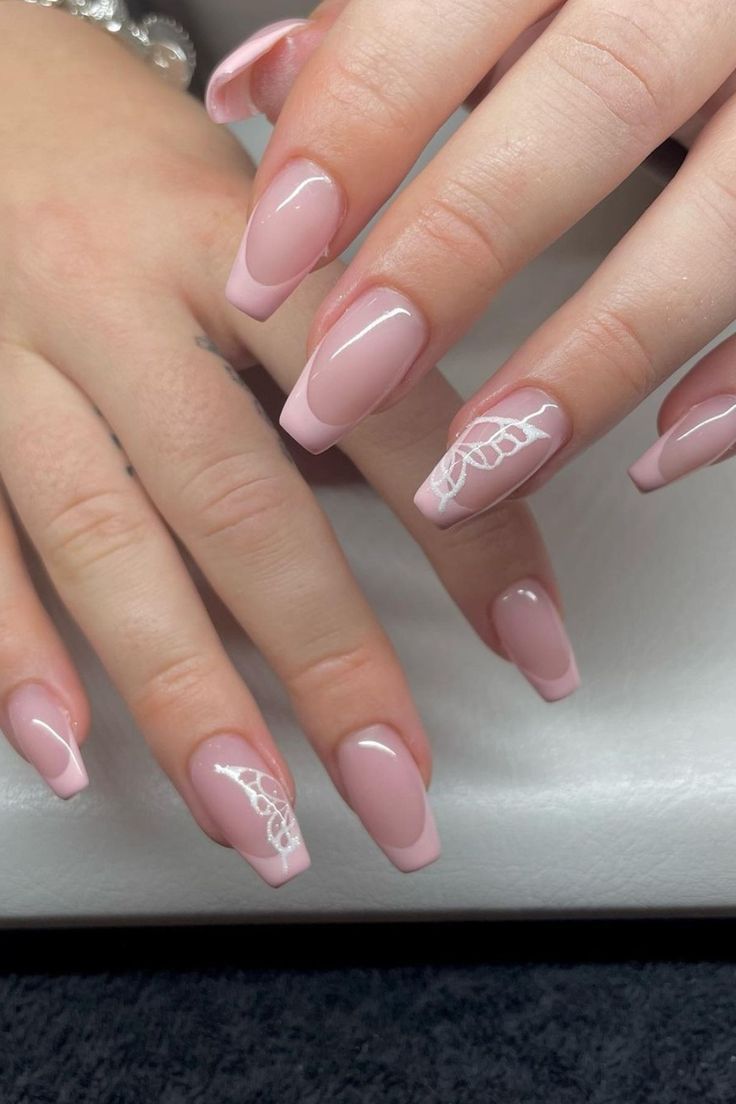 Sophisticated Soft Pink French Tip Nail Design with Lace Accents.