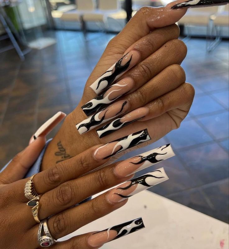 Chic Elongated Nail Design with Bold Black and White Flame Pattern