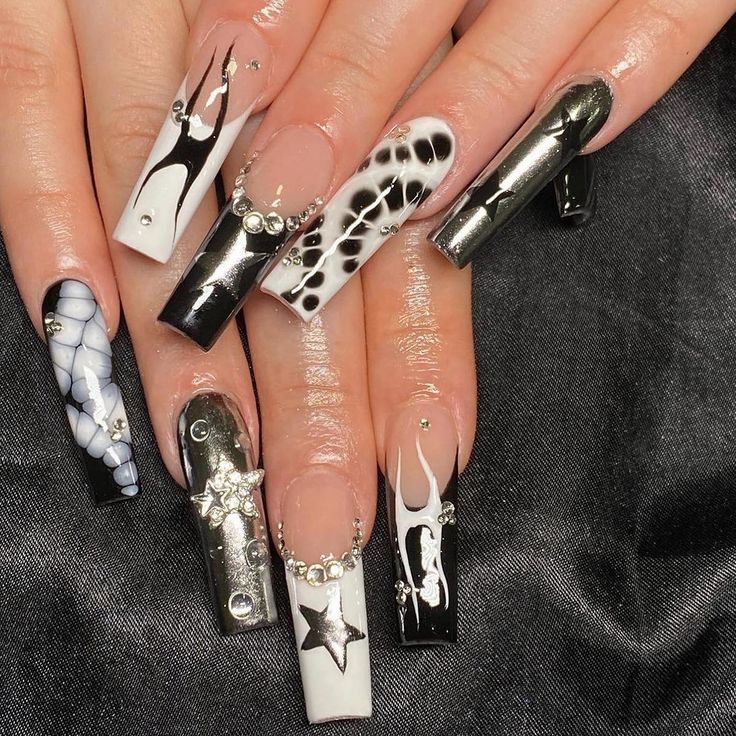 Chic Black and White Nail Art: Glossy and Matte Finishes with Artistic Patterns and Glam Accents.