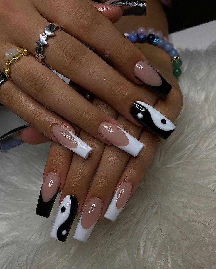 Chic Nail Art with Nude, White, and Black Colors: Elegant Half-Moons and Yin-Yang Designs on Modern Long Square Nails.