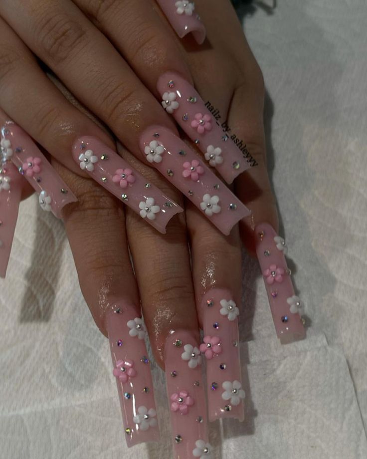 Elegant Floral Nail Design with Soft Pink Base and Sparkling Rhinestones.