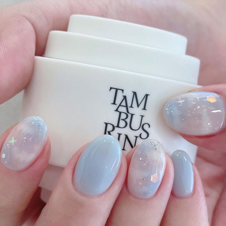 Celestial Pastel Nail Design: Whimsical Elegance with Iridescent Accents.